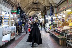 A woman walks at the old bazaar in the city of Shahr-e Ray, south of Tehran, on January 8, 2024.